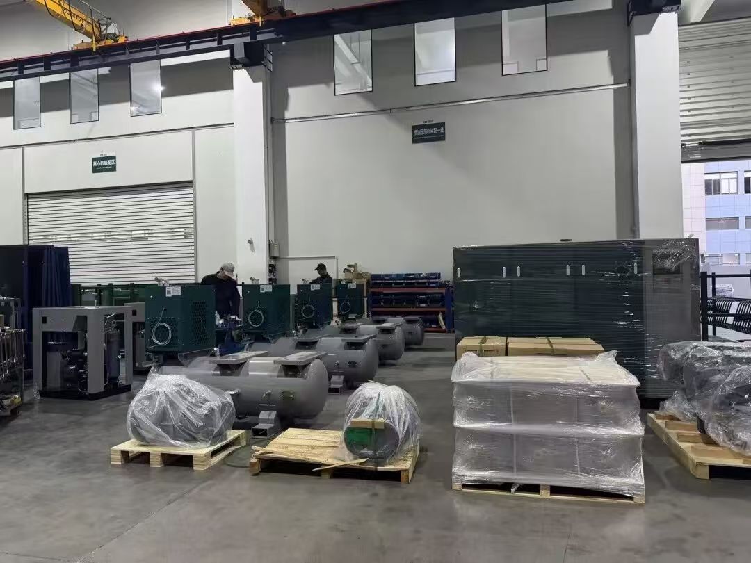 Industrial screw air compressor manufacturing workshop with air receiver tanks